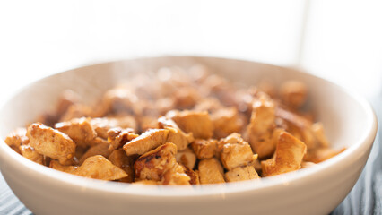 Juicy cubed chicken sautéed with garlic and minimal oil, steaming fresh. Healthy protein dish perfect for meal prep, fitness recipes, and food photography