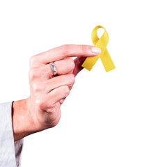 Woman&rsquo;s hand holding a yellow ribbon over a transparent background. Symbol of bladder cancer, endometriosis, and suicide prevention