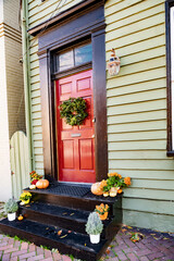  Seasonal wreath and fall decorations create a warm and spooky holiday atmosphere.