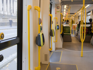 Empty Public Transport Interior With Yellow Poles and Handles