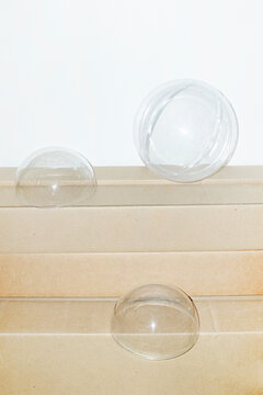 Clear plastic bubbles in brown cardboard boxes with hard flashlight