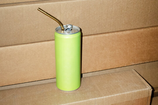 Hand holding green drink beverage can with hard direct flashlight