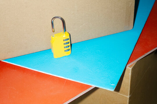 Yellow lock / padlock with code in colourful background with flashligh