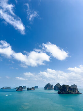 Islands and waters of Andaman sea under blue cloudy sky