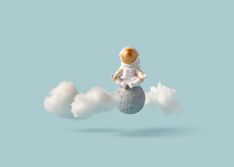 Astronaut meditating on moon with clouds