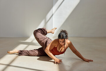 Yoga practice in a sunlit studio with flowing movements