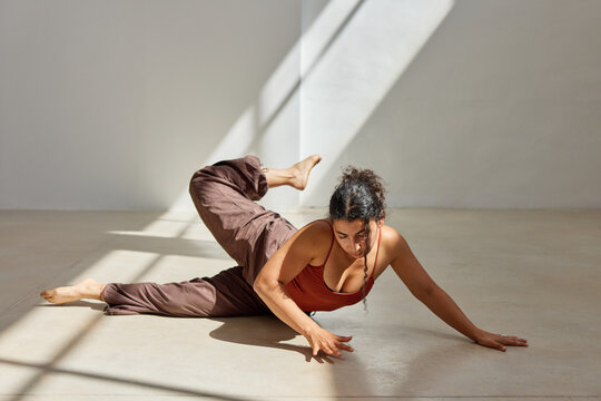 Yoga practice in a sunlit studio with flowing movements