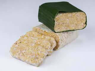 Tempeh or tempe isolated on white background . Tempeh is a traditional Indonesian food made from fermented soy beans. 