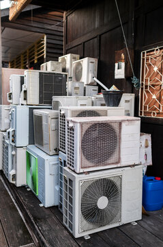 Air conditioner units piled in narrow alley