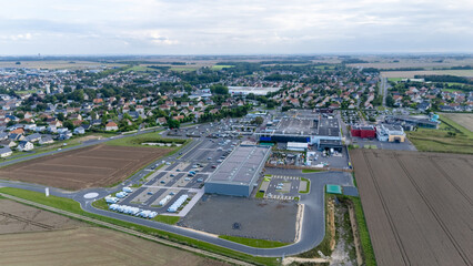 Aerial view of suburban shopping center and surrounding farmland.