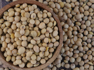 Flat lay Soy Beans seeds in wooden bowl with soy beans background. Top view