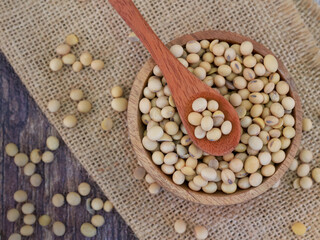 Flat lay Soy Beans seeds in wooden bowl on sackcloth or burlap, super food, vegetarian.