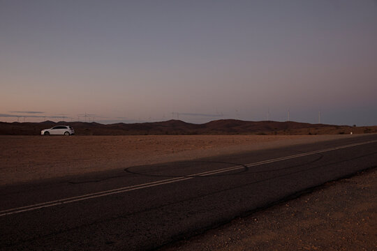 Car parked at side of road at dusk at Mundi Mundi Lookout