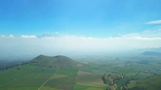 Aerial view of the Popocat&eacute;petl volcano in Mexico, seen from beautiful meadows. Mountains and volcanoes of Mexico, travel and vacation concept, 4k nature.
