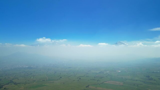 Aerial view of the Popocat&eacute;petl volcano in Mexico, seen from beautiful meadows. Mountains and volcanoes of Mexico, travel and vacation concept, 4k nature.
