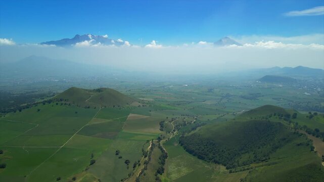 Aerial view of the Popocat&eacute;petl volcano in Mexico, seen from beautiful meadows. Mountains and volcanoes of Mexico, travel and vacation concept, 4k nature.
