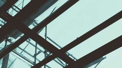 Industrial metal beams forming an abstract geometric composition in a construction setting with cool steel tones.