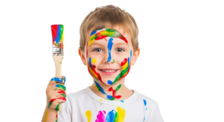 A young boy with paint on his face holding a paintbrush covered in colorful paint against black background