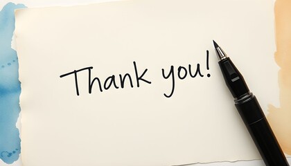 A handwritten "Thank you!" message on a textured paper with a pen.