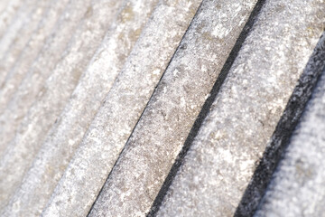 Close-up of shingles, slate roof. Abstract beige gray background with wavy texture. External design of the building. Roofing banner texture, background for roofing banner. Copy space