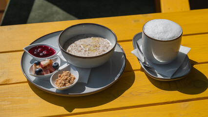 Reserved breakfast at a cafe. A plate of porridge on a table in a street cafe. 