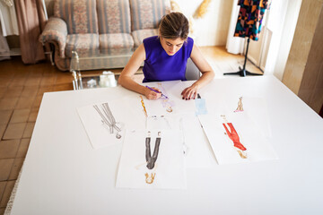 Fashion designer drawing at workspace