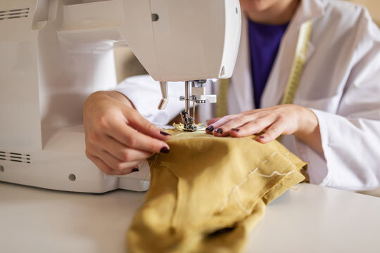 Fashion designer sewing at machine