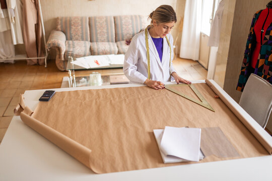 Fashion designer drafting garment patterns