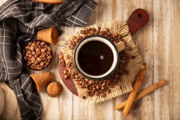 Cafe de Olla. Traditional Mexican coffee and basic ingredients for its preparation, coffee, cinnamon and piloncillo, served in a metallic cup called 