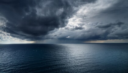 dramatic storm clouds over a calm ocean the dark heavy clouds contrast beautifully with the serene water creating a captivating scene