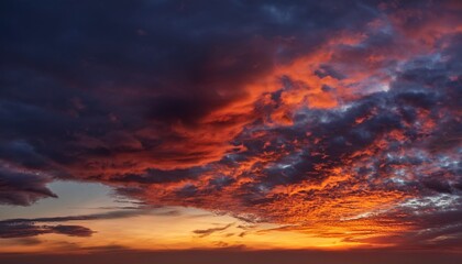 Fototapeta premium dramatic sky with fiery colors and textured clouds at twilight during spectacular atmospheric display