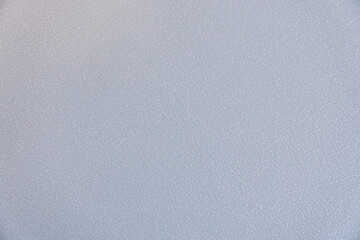 A grey background with a few white dots