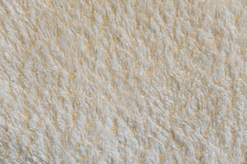 A close up of a white towel with a fuzzy texture