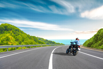 motorcycle drive on the coastal road landscape in colorful beach. Highway view on the shores of the mediterranean sea in summer vacation travel. Beach trip on beautiful travel road in ocean coast.
