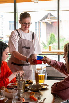Waitress processing card payment at restaurant table
