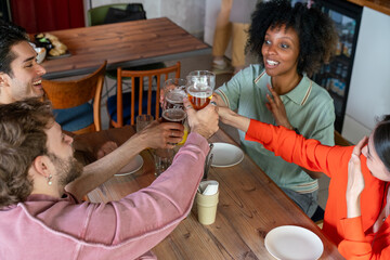 Friends toasting drinks at cafe table