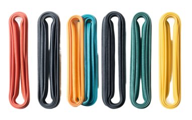 Set of resistance bands in different strength levels arranged for home fitness and strength training workouts isolated on transparent background PNG