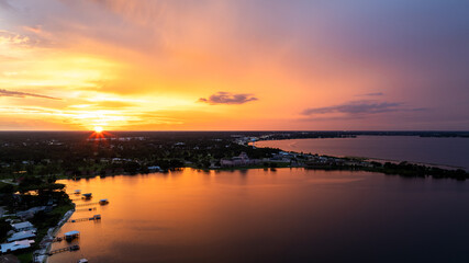 Obraz premium Aerial Drone View of Lake Jackson, Sebring Florida at Sunset with Vibrant Sky Reflections 
