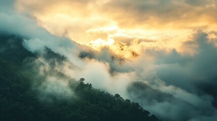 Fototapeta premium A mountain covered in clouds with a sun in the sky