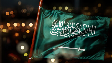 Saudi Arabia national flag waving with blurred bokeh lights background. Concept of Saudi Arabia National Day