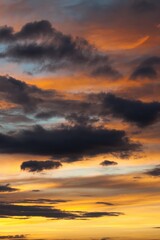 The sky is filled with clouds and the sun is setting. Vertical background, wallpapers.