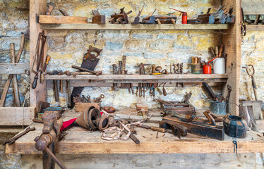 Vintage woodworking tools against a wall