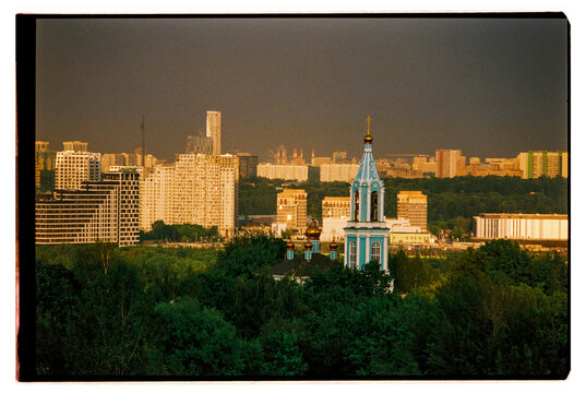City skyline with a church in the foreground during sunset