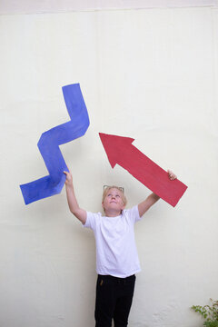 Boy with cardboard  zigzag and arrow 