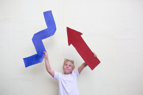 Boy with cardboard  zigzag and arrow 