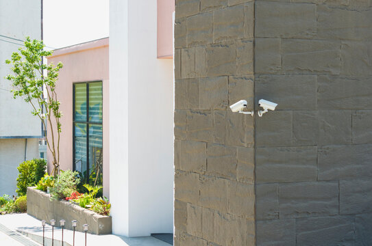 Security cameras on modern building exterior.