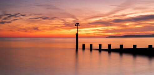 Bournemouth beach illuminated by the setting sun at sunset