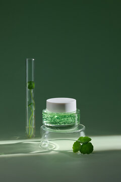 A stylish skincare product is presented with centella asiatica leaves
