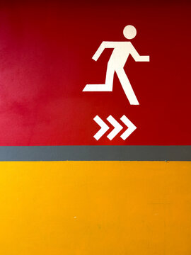 Minimalist Emergency Evacuation Icon on the Wall of the Parking Lot