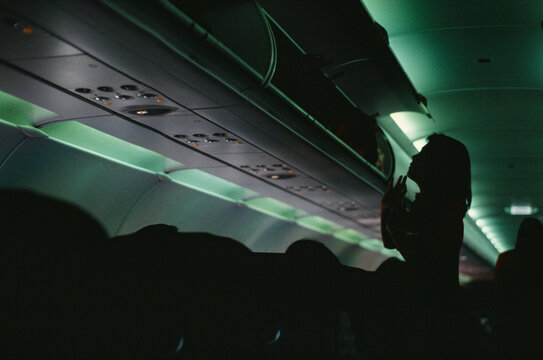 35mm film flight attendant checking luggage in silhouette